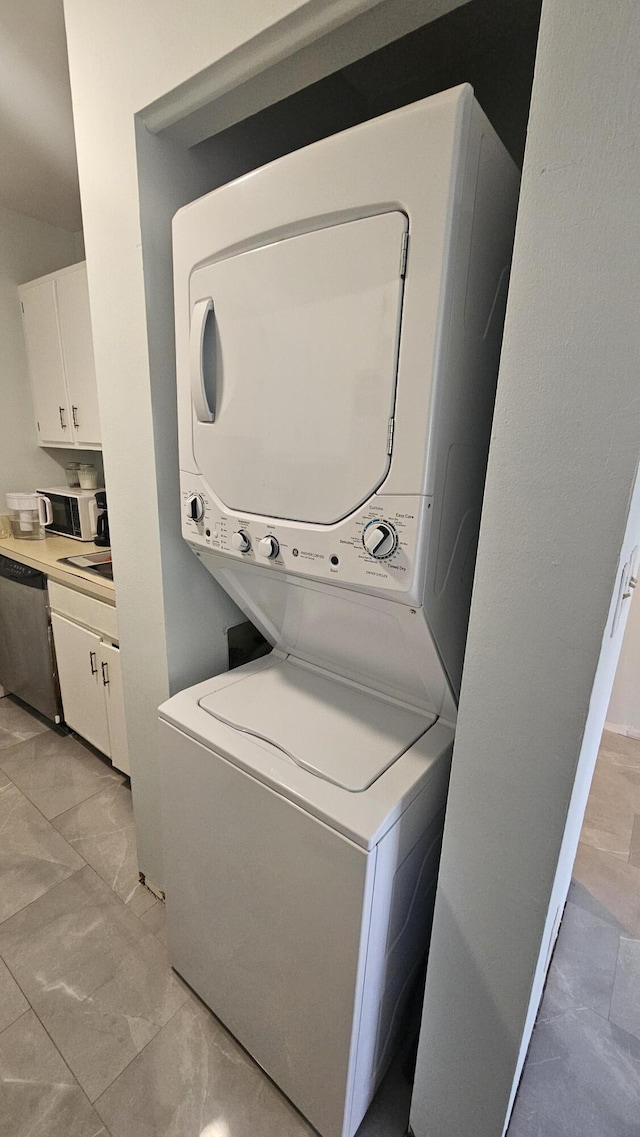 laundry area with stacked washing maching and dryer and laundry area