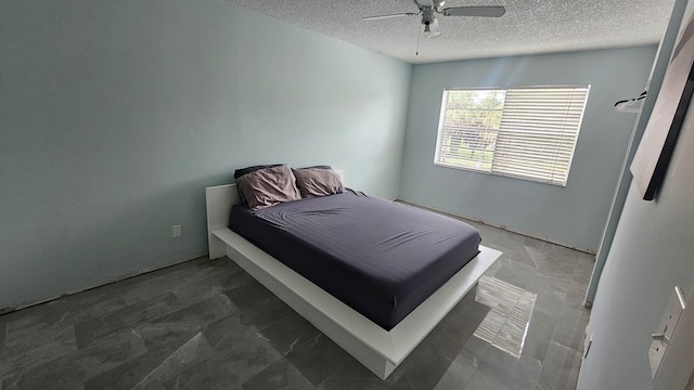 bedroom with a textured ceiling and ceiling fan