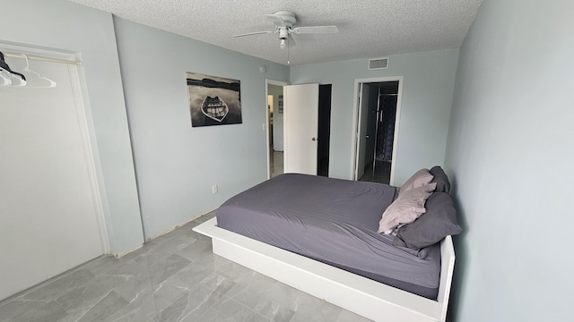 unfurnished bedroom featuring a textured ceiling, visible vents, and a ceiling fan