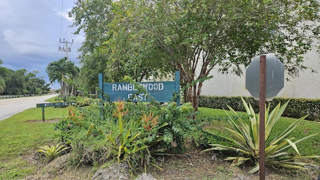 community / neighborhood sign with a yard