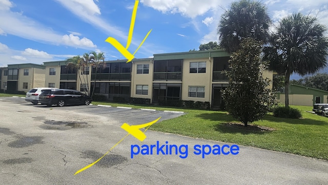 view of property with uncovered parking