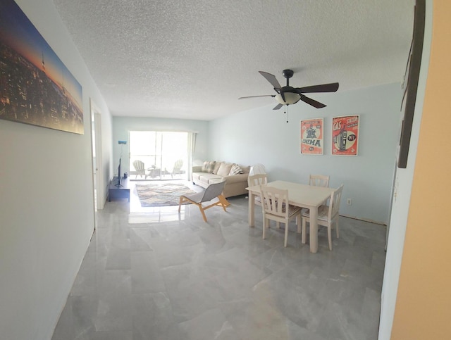 dining room with a textured ceiling and ceiling fan