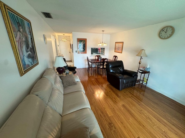 living room featuring hardwood / wood-style floors and a notable chandelier