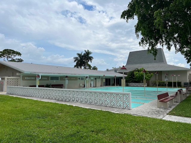 view of pool with a yard