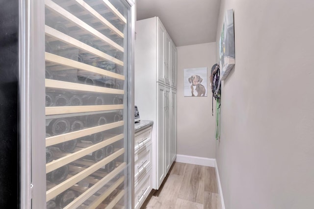 interior space with light hardwood / wood-style floors and beverage cooler