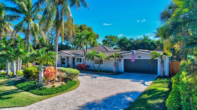 view of front of home featuring a front lawn and a garage