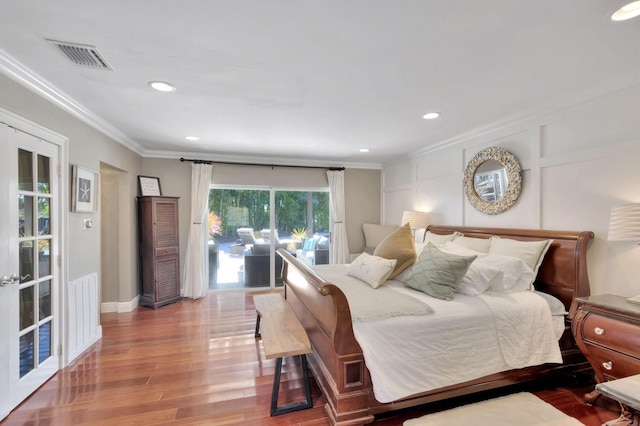 bedroom featuring hardwood / wood-style floors, access to outside, and crown molding