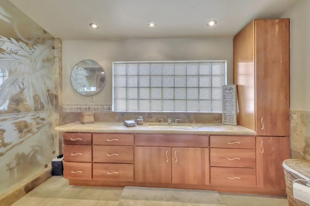 bathroom with tile patterned flooring, vanity, and a wealth of natural light