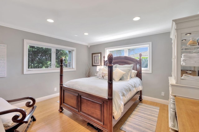 bedroom with light hardwood / wood-style floors and ornamental molding