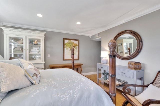 bedroom with hardwood / wood-style floors and ornamental molding