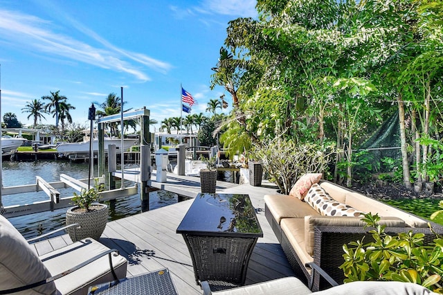 view of dock with an outdoor living space and a water view