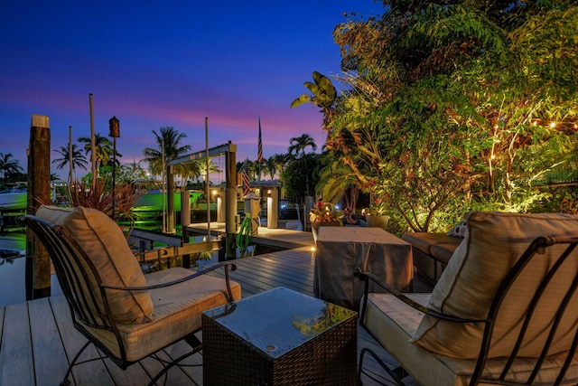 deck at dusk with an outdoor hangout area