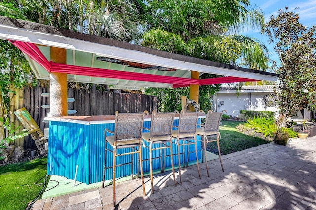 view of patio featuring an outdoor bar