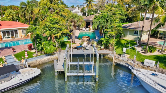 view of dock with a water view and a patio