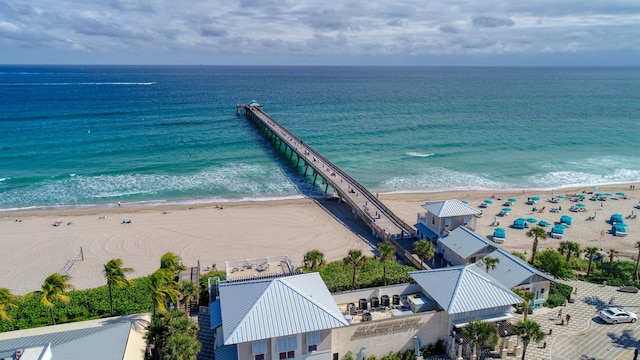 drone / aerial view with a beach view and a water view