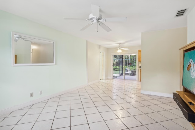 spare room featuring ceiling fan and light tile patterned floors