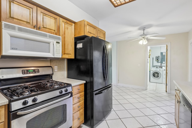 kitchen with light tile patterned floors, ceiling fan, stainless steel gas stove, black fridge, and washer / dryer