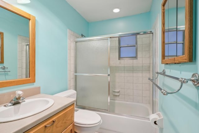 full bathroom with toilet, vanity, and enclosed tub / shower combo