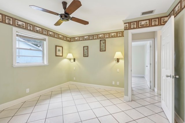 tiled empty room with ceiling fan