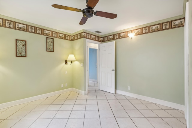 tiled spare room featuring ceiling fan