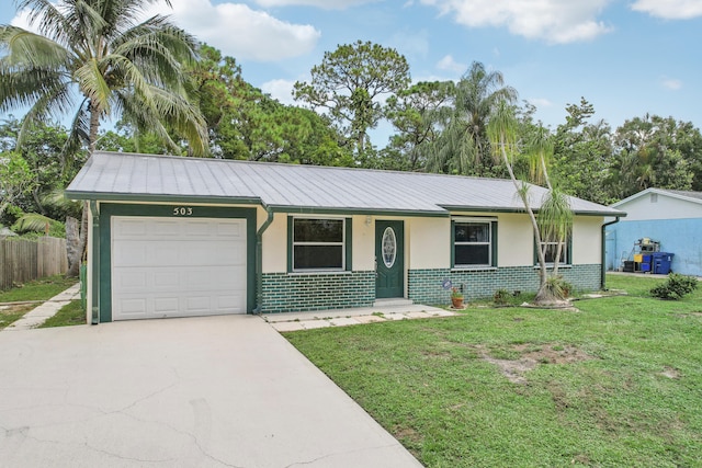 ranch-style house featuring a garage and a front lawn