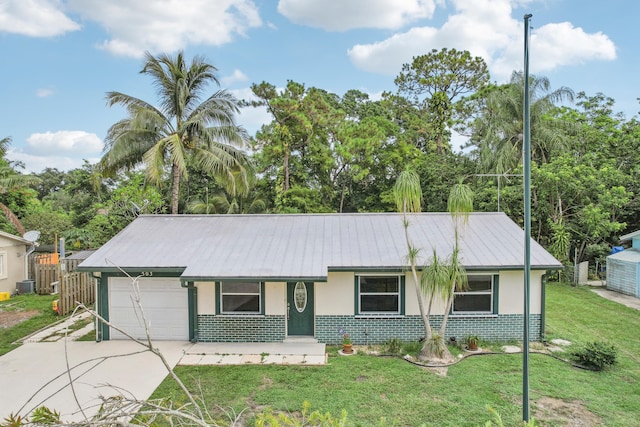 ranch-style home featuring central air condition unit, a garage, and a front lawn