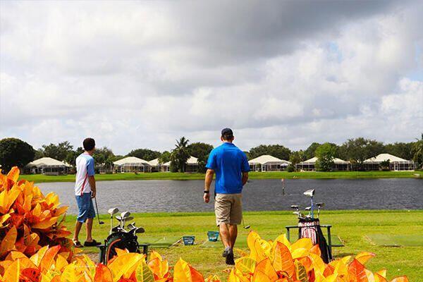 view of community with a water view and a lawn