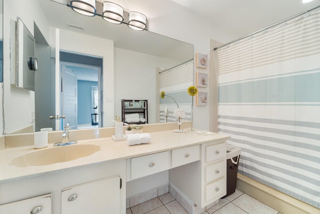 bathroom featuring vanity, tile patterned floors, and curtained shower