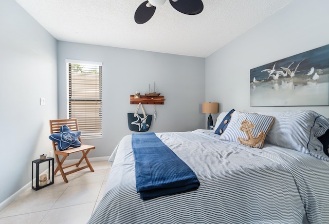 tiled bedroom featuring a textured ceiling and ceiling fan