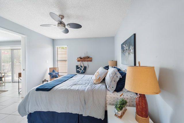 tiled bedroom with a textured ceiling and ceiling fan