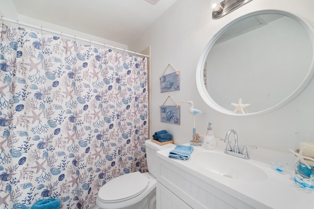 bathroom featuring toilet, vanity, and a shower with shower curtain