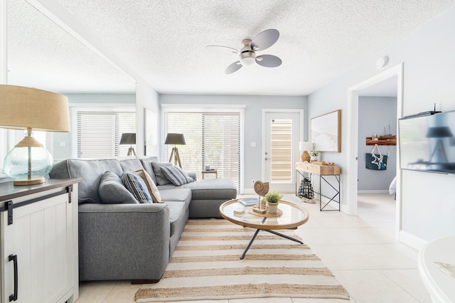 tiled living room featuring a textured ceiling and ceiling fan