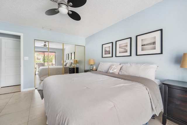 bedroom with a closet, ceiling fan, a textured ceiling, and light tile patterned floors