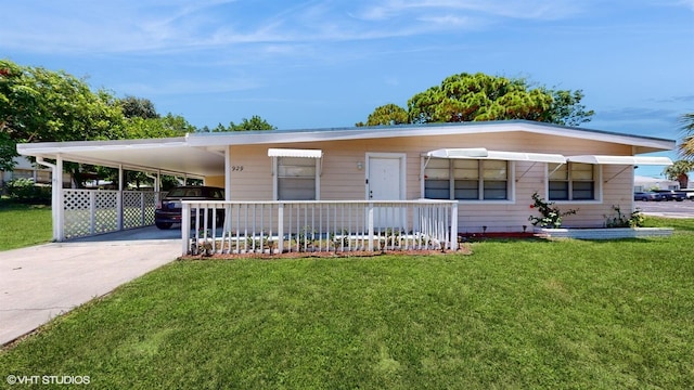 view of front of house with a front lawn and a carport