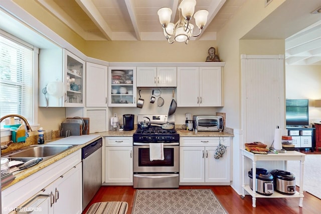 kitchen featuring white cabinets, dark wood-type flooring, and appliances with stainless steel finishes