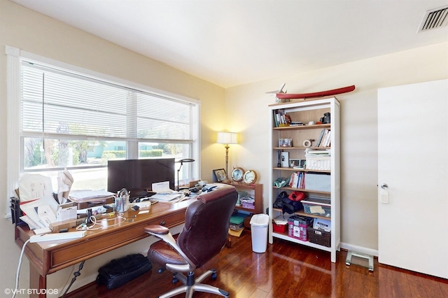 home office with dark wood-type flooring