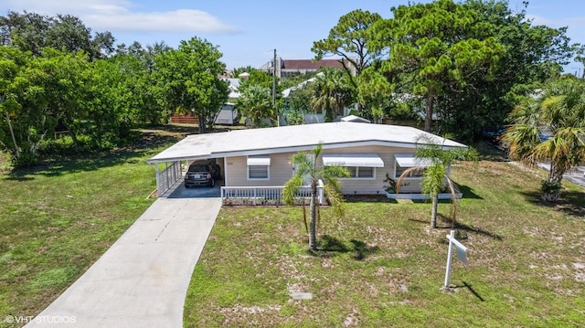 view of front of home with a front lawn and a carport