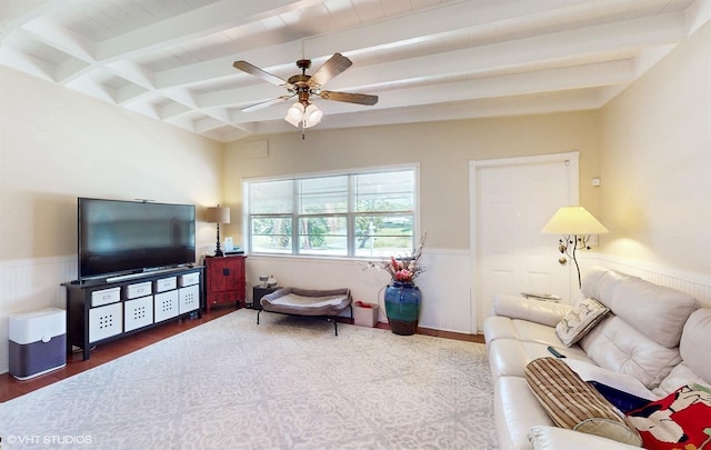 living room with hardwood / wood-style floors, ceiling fan, and beam ceiling