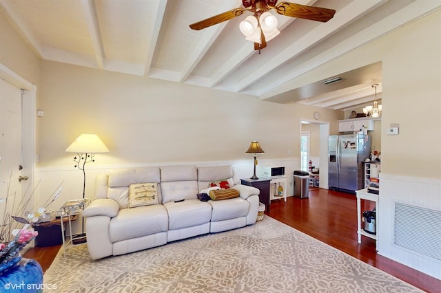 living room featuring wood-type flooring, ceiling fan with notable chandelier, and lofted ceiling with beams