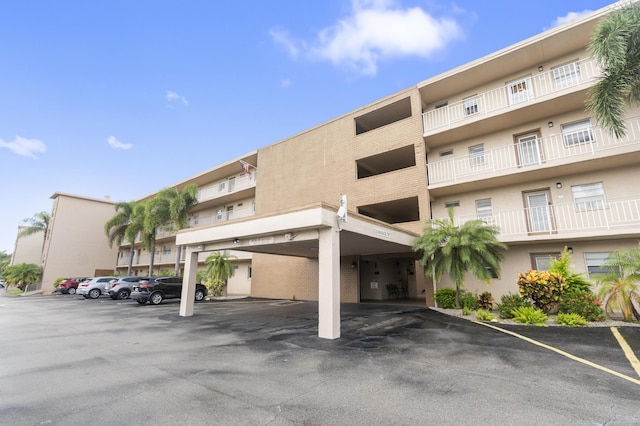 view of building exterior with uncovered parking