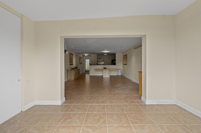 interior space featuring light tile patterned floors and baseboards