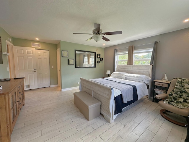 300 NE 26th Ave Unit 114, Boynton Beach, FL 33435 - bedroom with light wood finished floors, a ceiling fan, recessed lighting, and visible vents