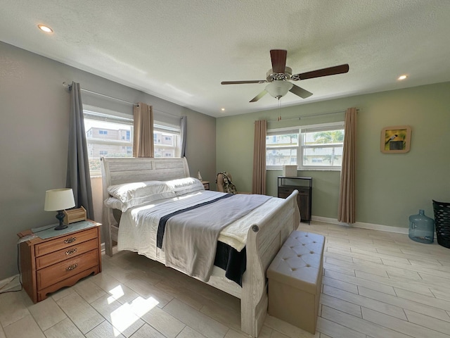 300 NE 26th Ave Unit 114, Boynton Beach, FL 33435 - bedroom with a ceiling fan, a textured ceiling, and recessed lighting
