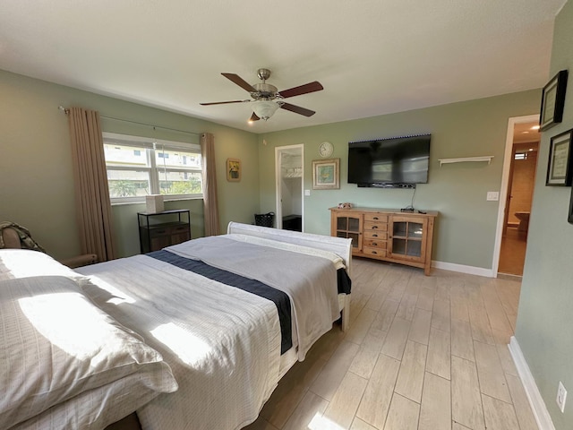 300 NE 26th Ave Unit 114, Boynton Beach, FL 33435 - bedroom with a ceiling fan, baseboards, and light wood-style flooring