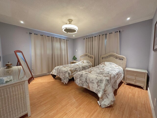 300 NE 26th Ave Unit 114, Boynton Beach, FL 33435 - bedroom featuring recessed lighting, a textured ceiling, and light wood-type flooring