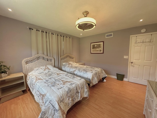 300 NE 26th Ave Unit 114, Boynton Beach, FL 33435 - bedroom with recessed lighting, baseboards, visible vents, and light wood-type flooring