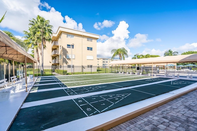 surrounding community featuring shuffleboard and fence