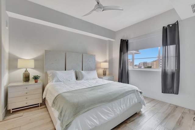 bedroom with light hardwood / wood-style flooring and ceiling fan