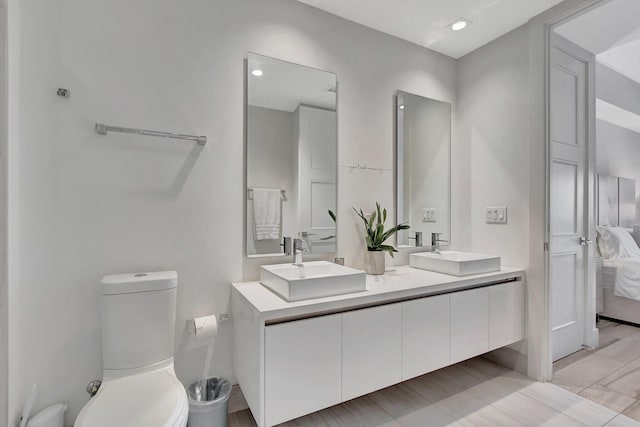 bathroom featuring double vanity, tile patterned flooring, and toilet