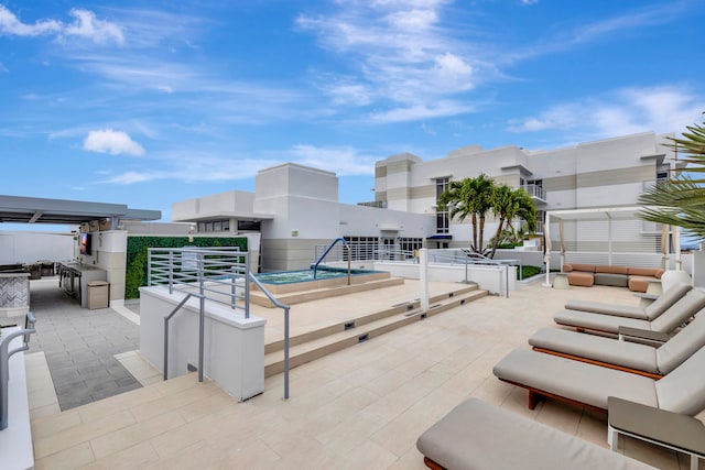 view of pool with a hot tub